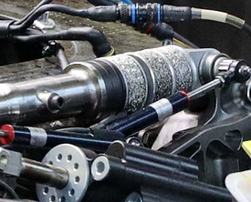 Wire mesh dampers and bumpstops for racing and motorsports