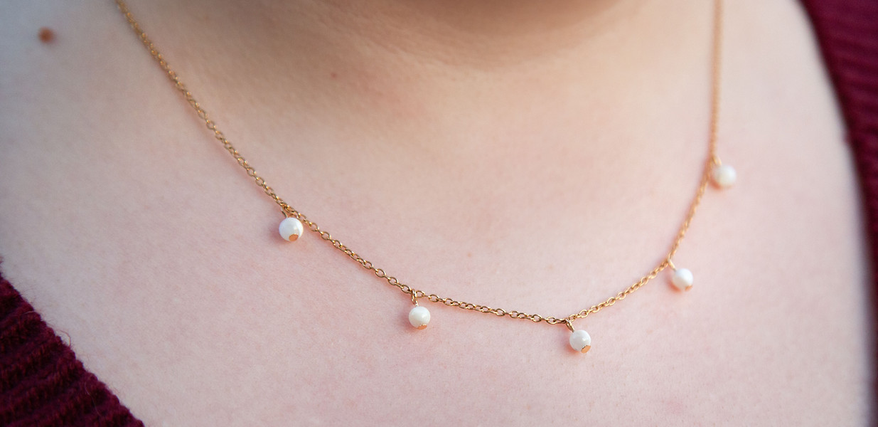 The Angel Necklace - Five mother of pearl beads on a gold chain.
