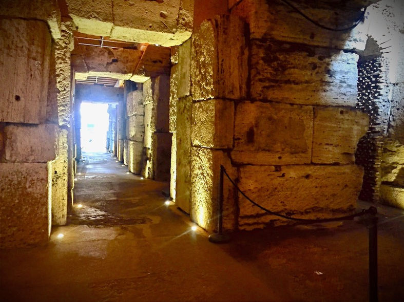 Inside the underground tunnels of the Colosseum during a small-group guided tour. 