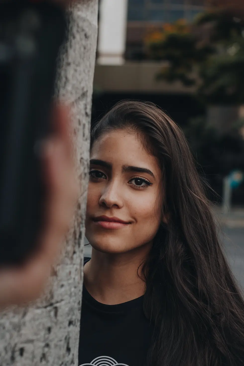 The image shows a model smiling at the camera, showing off another designed t-shirt.