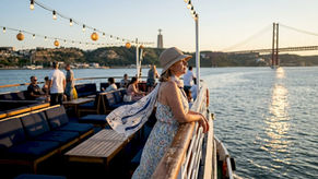 Tourist on boat admiring Lisbon river views