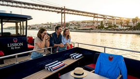 Travelers enjoy Lisbon sightseeing from river boat