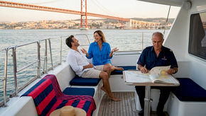 People relaxing on Lisbon sailboat at harbor