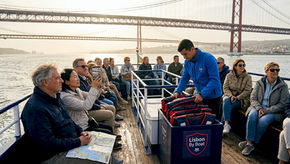 Tourists enjoying boat cruise on Tagus River