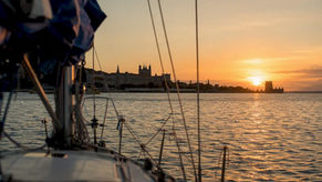 Sailing yacht bow on Tagus River at sunset