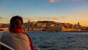 Lisbon skyline glowing above the Tagus at sunset