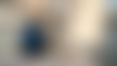 Sailor on deck with Lisbon bridge and skyline