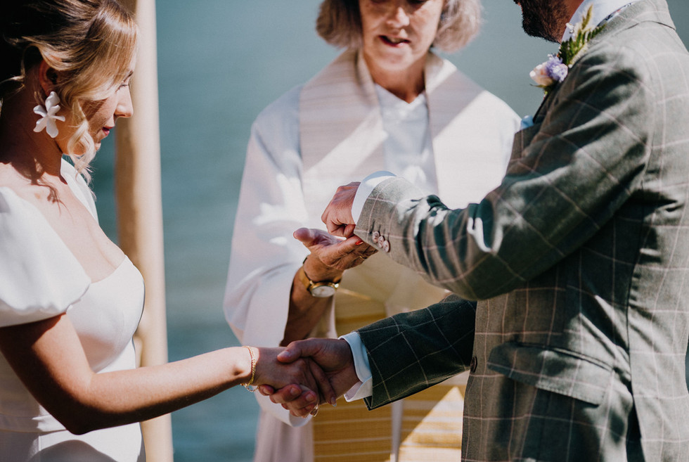 wedding rings being exchanged at ceremony on nelson bc
