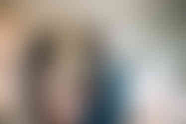 bride pinning corsage on groom