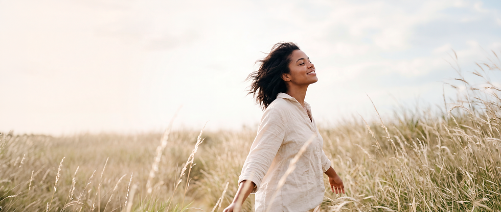 Woman standing in a golden field at sunset, representing K&I Healthcare Services mental health support in Maryland
