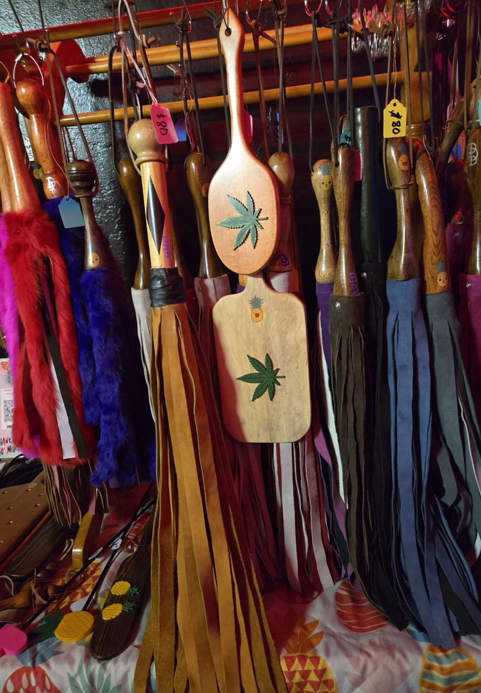 A vibrant collection of handcrafted paddles and floggers, by D_DungeonDesigns.