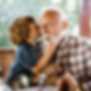 young boy kissing his grandpa's cheek