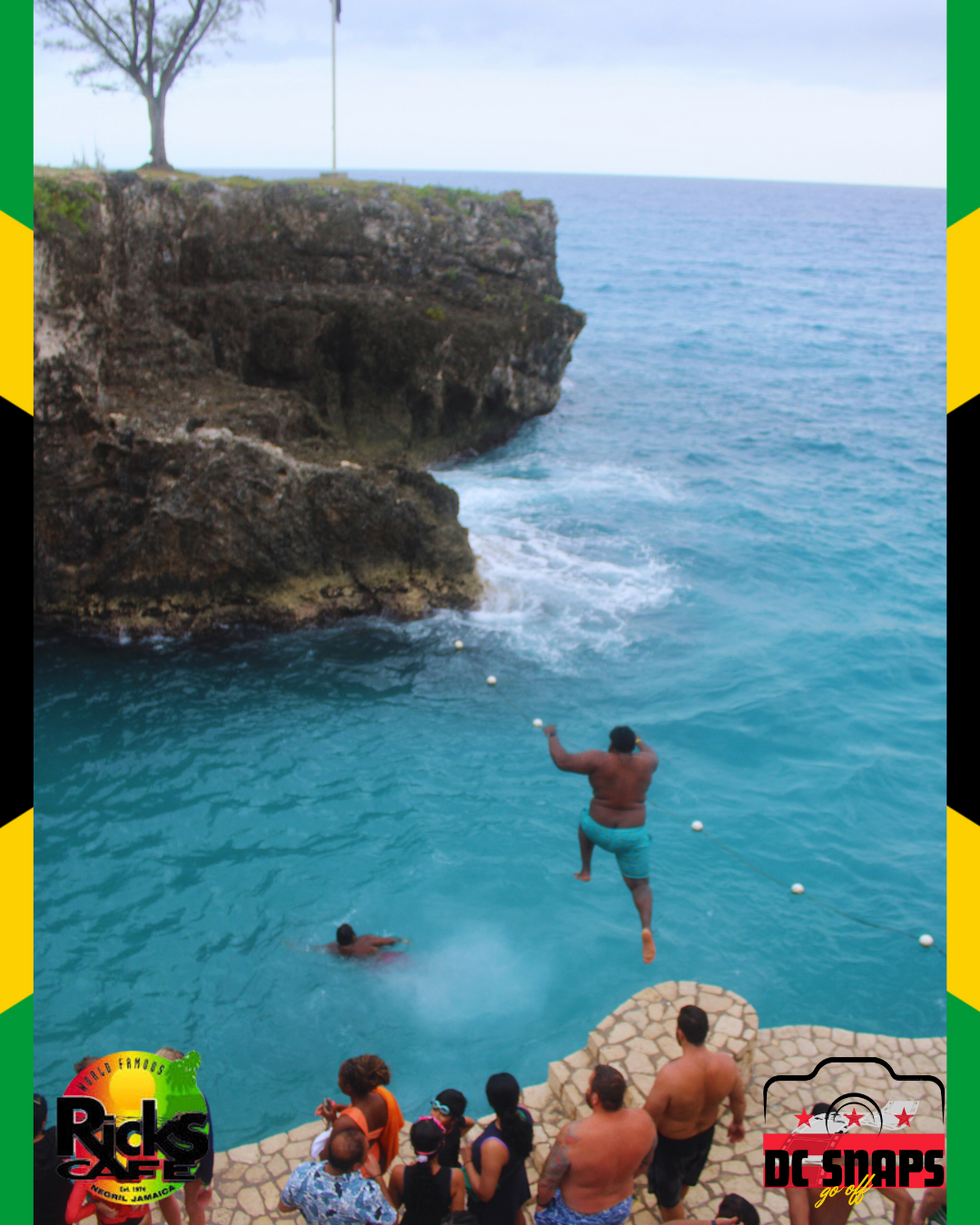 Thrill-seekers leap from Negril’s famous cliffs into turquoise Caribbean waters at Rick’s Café, Jamaica.