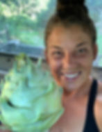 Smiling woman holding a large kohlrabi vegetable