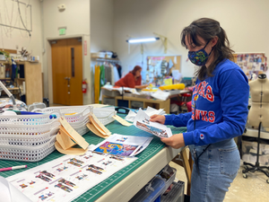 Costume technician Maddie Simmons sorting cut fabric.