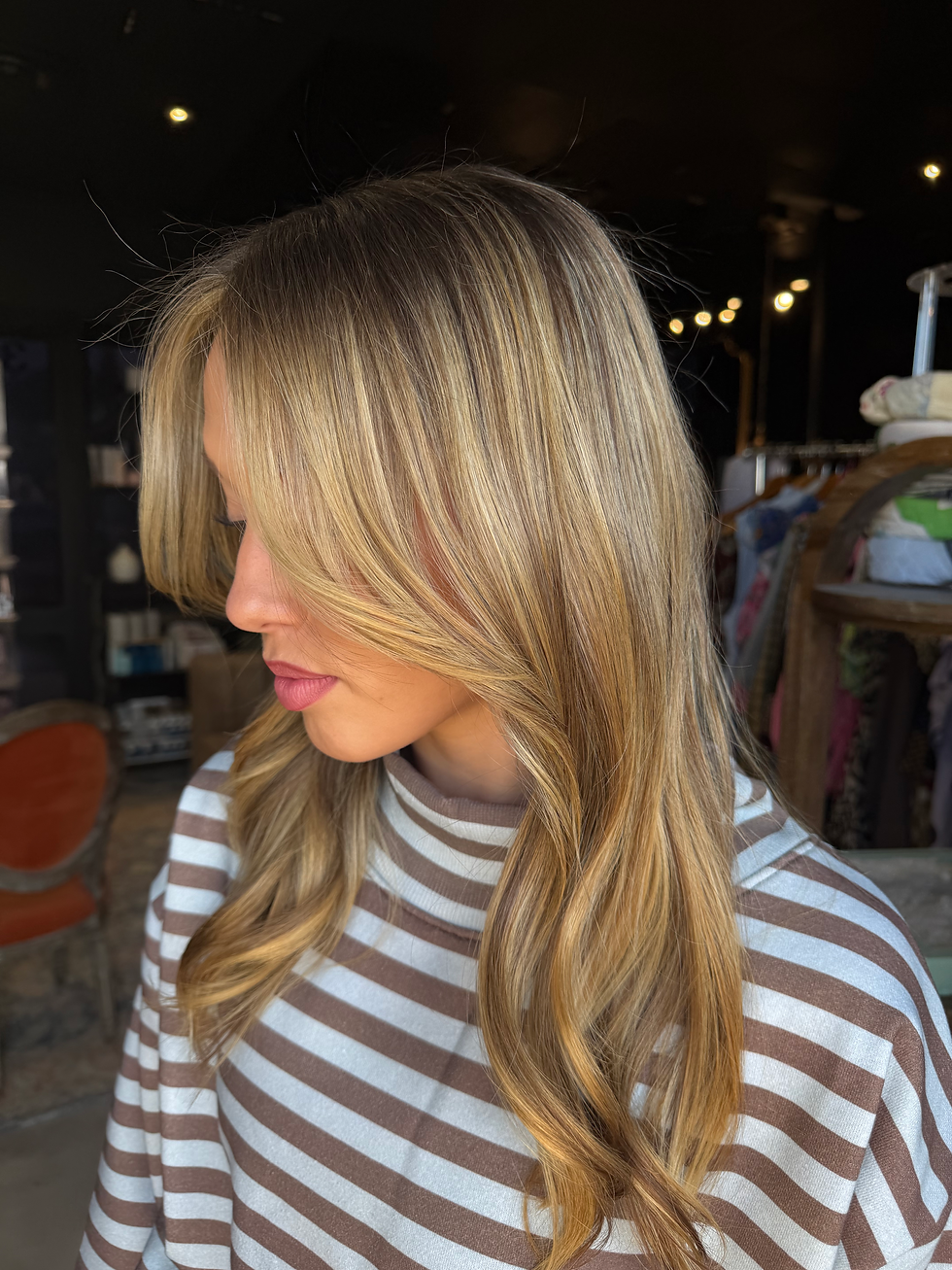 Woman with smooth blonde hair by a natural hair care brand.