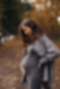 Beautiful pretty pregnant woman outdoors in autumn park, happily expecting baby, happy mom