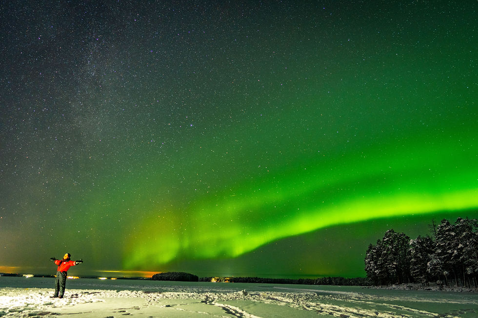 Northern Lights over a river in Rovaniemi, Finland