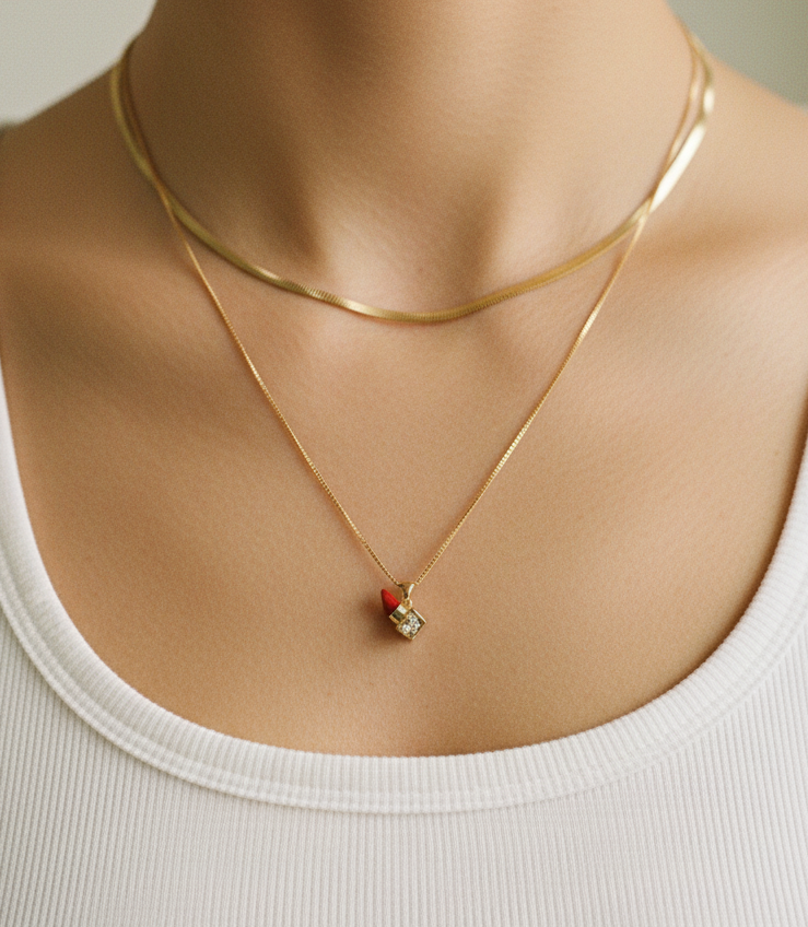 Closeup of Sana's Cute Lipstick Pendant Chain along with another chain worn on a neck.