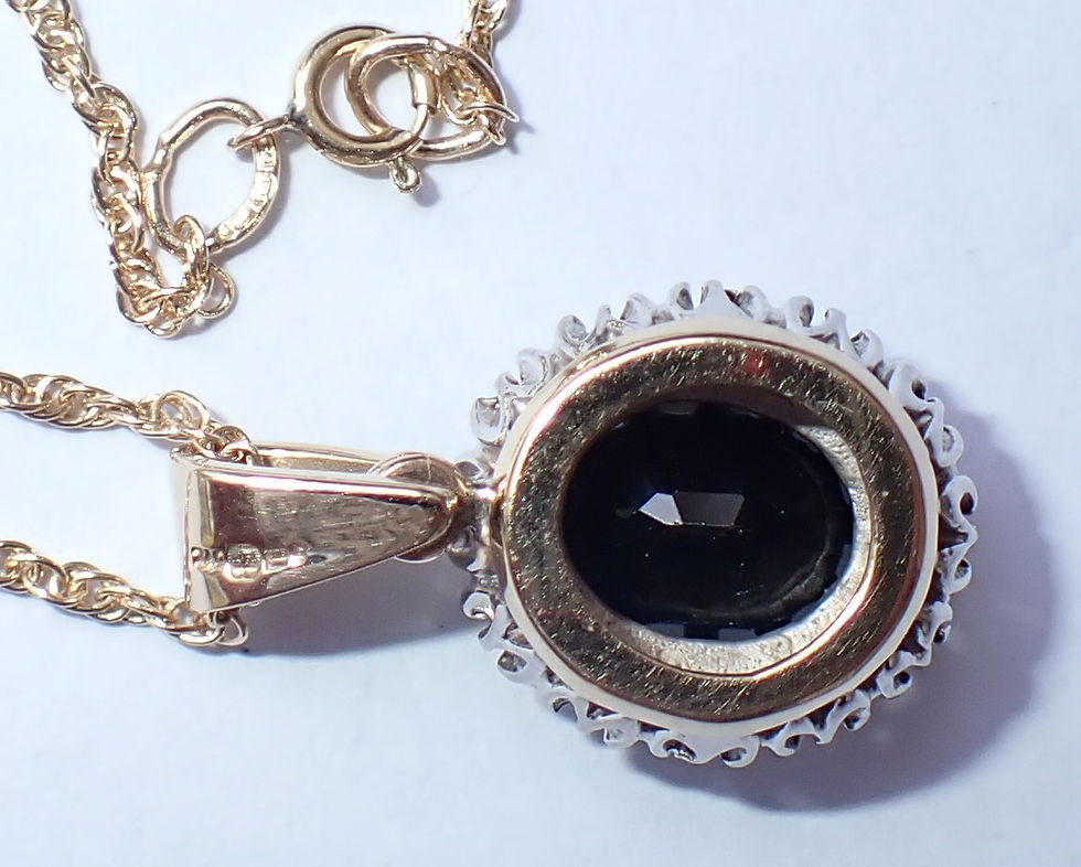 Thumbnail: 9ct gold black sapphire and diamond halo necklace.