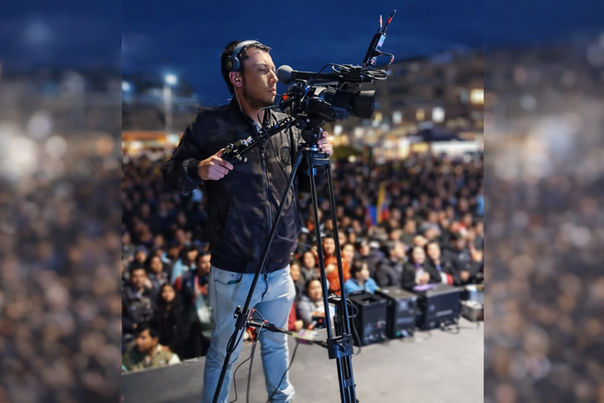 Camarógrafo filmando concierto en vivo frente a público masivo