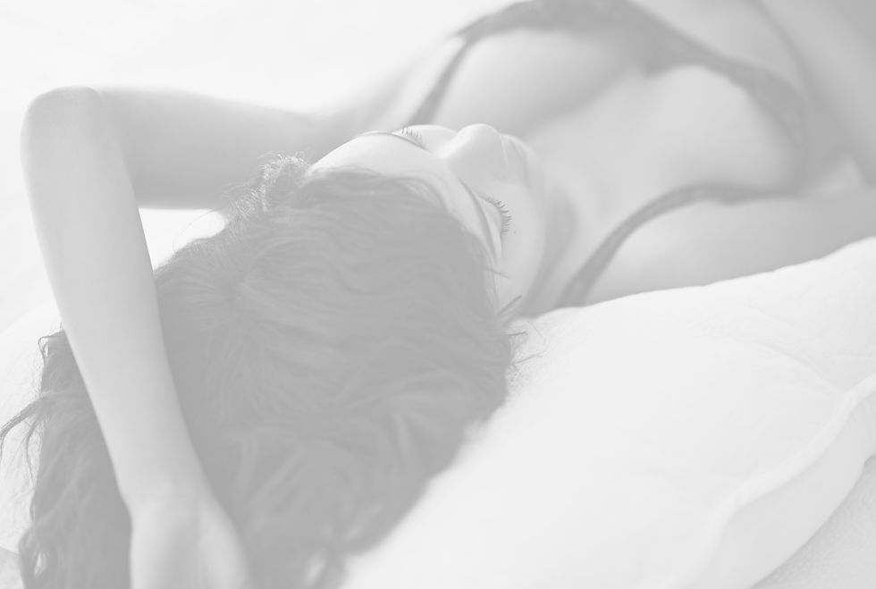 Young Woman Lying in Bed Wearing Lingerie_edited.jpg