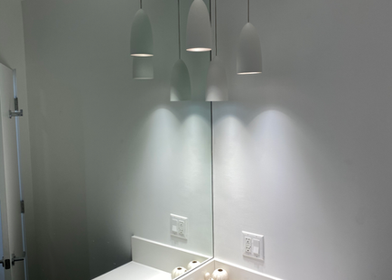 Clean lines and impeccable lighting are highly appealing in these bathrooms.