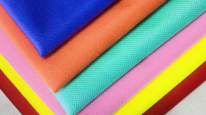Polypropylene Spunbond Nonwoven Fabric with different colours on white background.jpg