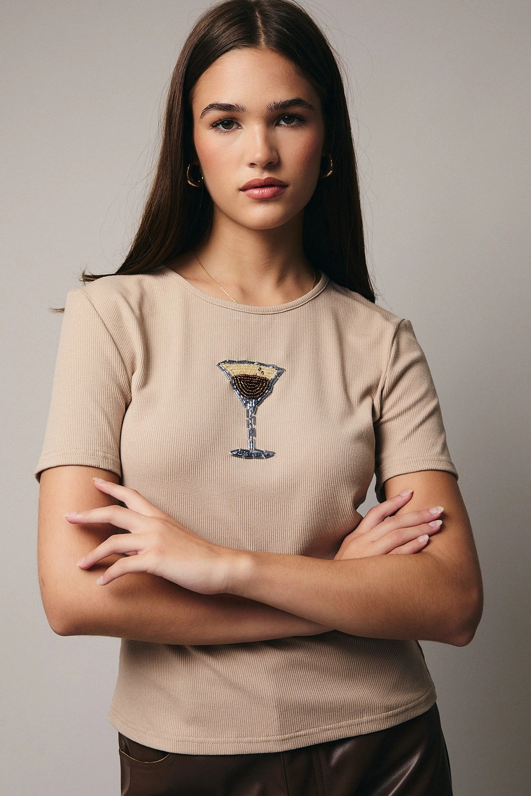 woman wearing beige tee with beaded espresso martini graphic