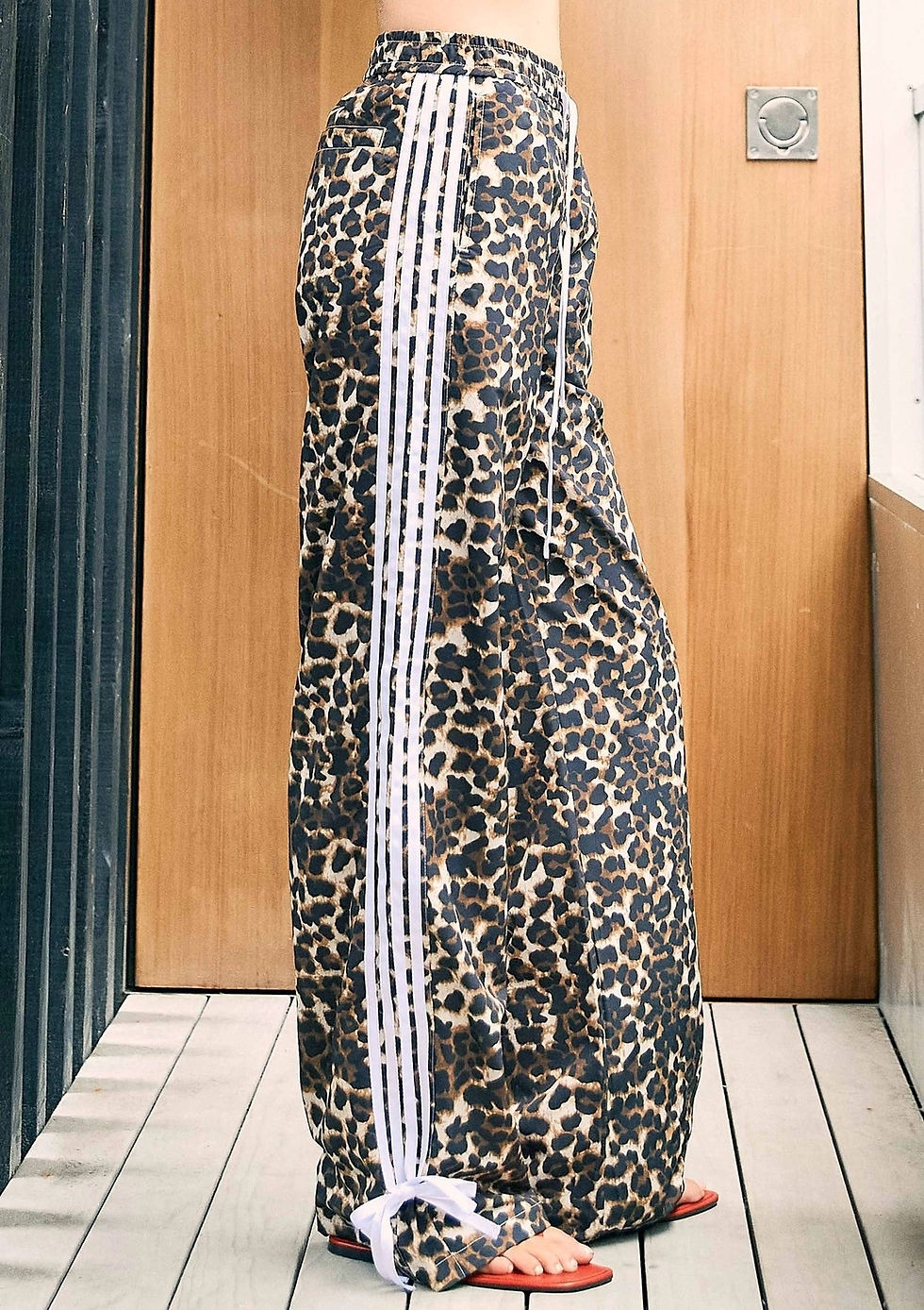 Thumbnail: High-waisted leopard print pants with relaxed fit, elastic waistband, and ribbon side detail