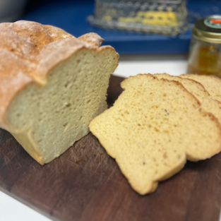 Fresh homemade sandwich white bread cooling on a wire rack after baking.
