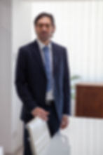 Tefkros Haholiadis, Founder of the Cyprus law firm, standing in a professional office setting