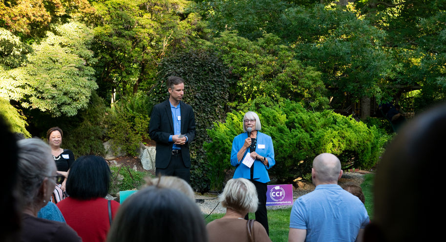 CCF co-chairs Rep. Ruth Kagi (Ret.) and Sam Mendez deliver remarks to guests, candidates, and board members while surrounded by beautiful foliage and flowers at the Dunn Gardens