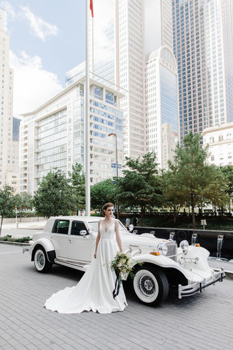 Bride standing next to Excalibur getaway vehicle
