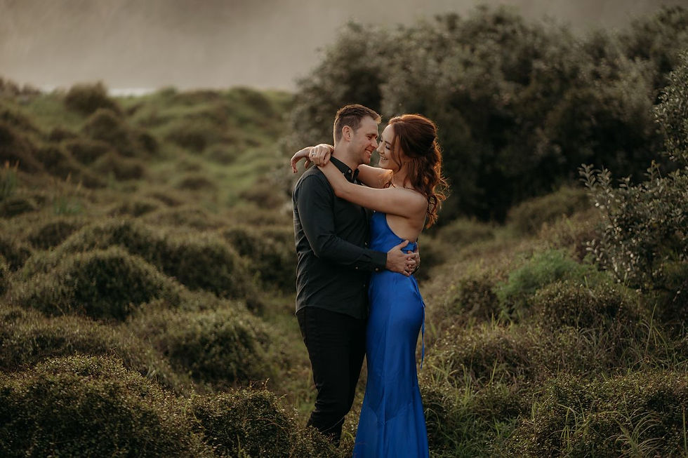 Couple hugging in green landscape, candid portrait