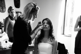 Black-and-white: stylist curling hair at salon station