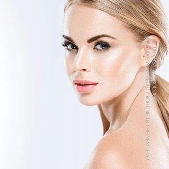 Close-up portrait of a blonde woman with radiant, natural makeup.