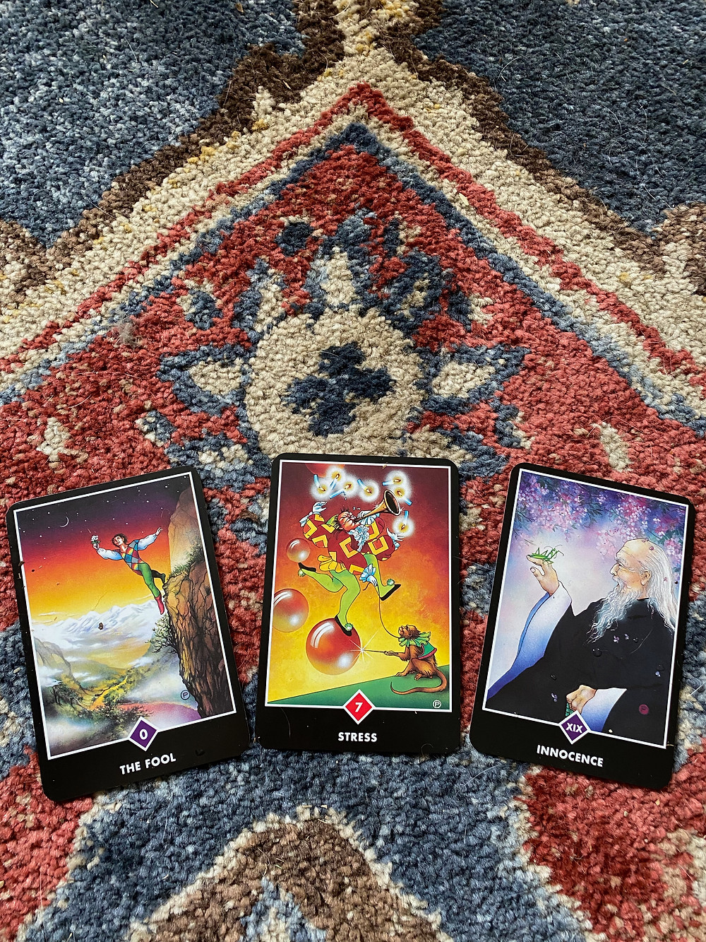 Taro cards depicting the Fool, Stress, and the Sage