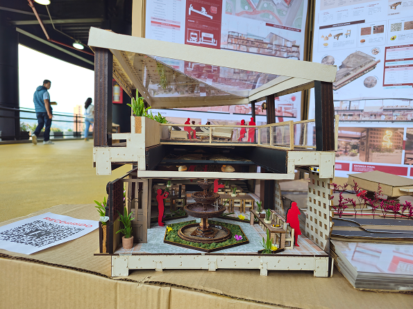 Close-up of the sectional physical model showing the restaurant courtyard, fountain and multi-level structure