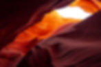 A cave opening with light shining through, representing the clarity, vision and bright future that DRB Group helps clients wo