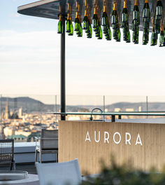 Bottles hang at the Aurora Bar with a view of the city.
