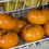 Thumbnail: Close up of Orange Jazz tomatoes in a white wire basket. Large, bold dark yellow tomatoes with orange stripes.