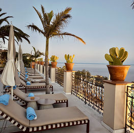 Beach chairs overlooking a stunning view in Taormina Sicily