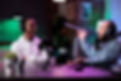 pov-male-bloggers-vlogging-podcast-talk-camera-using-streaming-equipment-studio-with-neon-