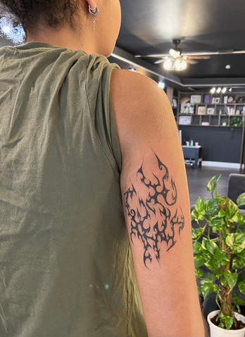 Person's arm with new abstract flame tattoo