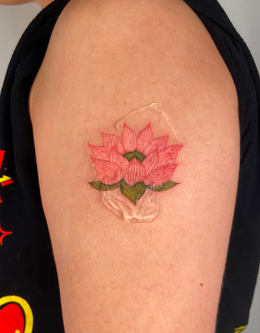 Pink lotus flower tattoo on shoulder