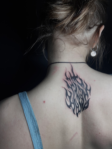 Black flame tattoo on nape