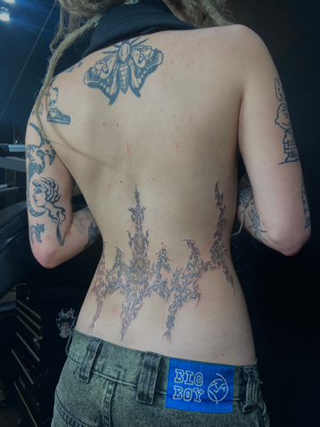 Person's back with floral tattoo