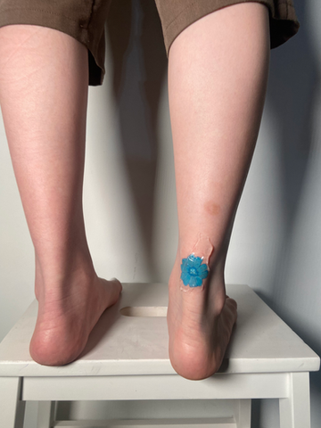 Blue flower ankle tattoo