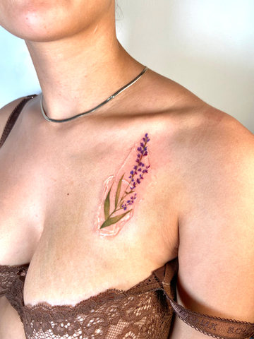 Lavender floral tattoo on collarbone